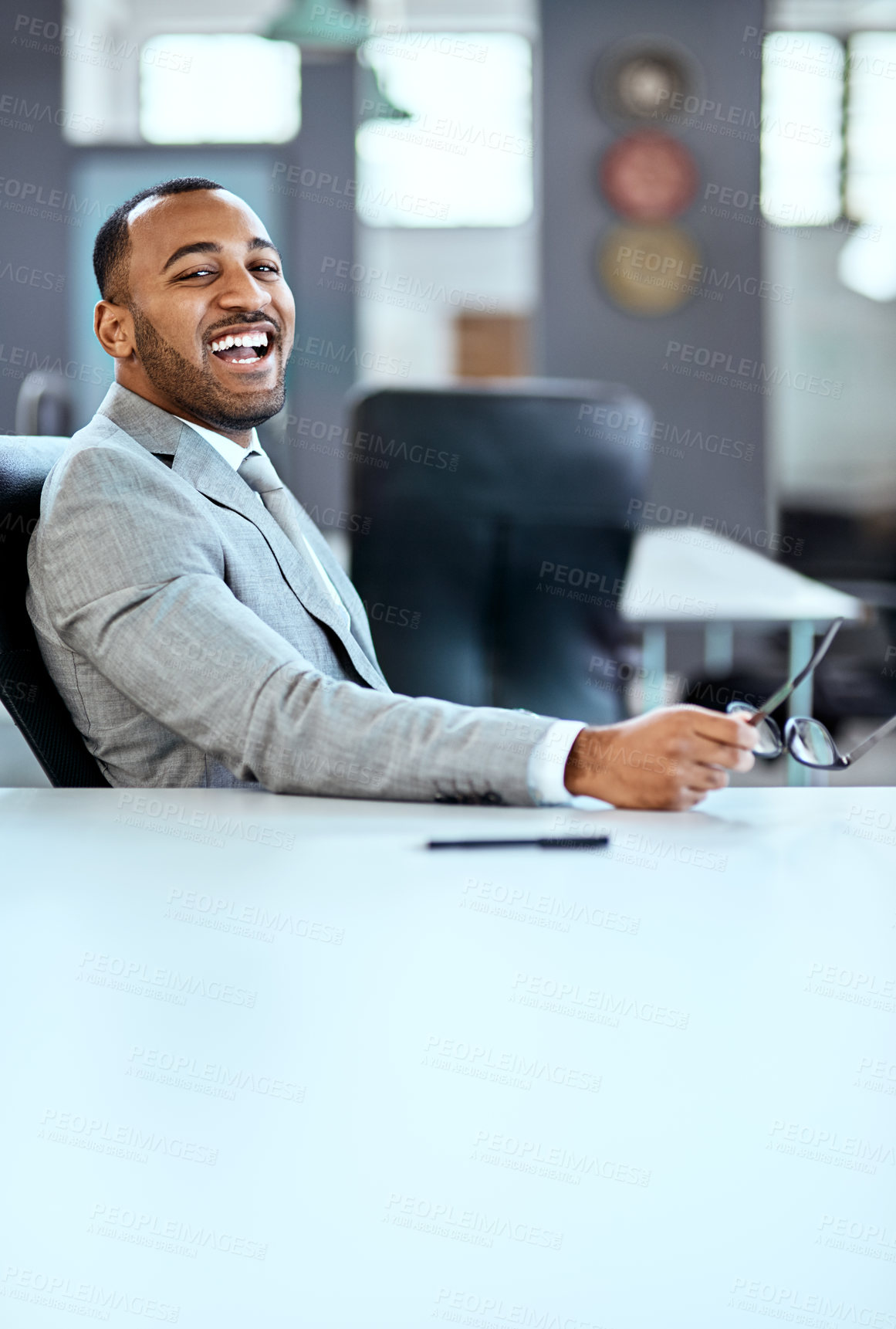 Buy stock photo Portrait of a young businessman sitting in an office