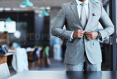 Buy stock photo Closeup shot of an unrecognizable businessman fastening the button on his suit in an office