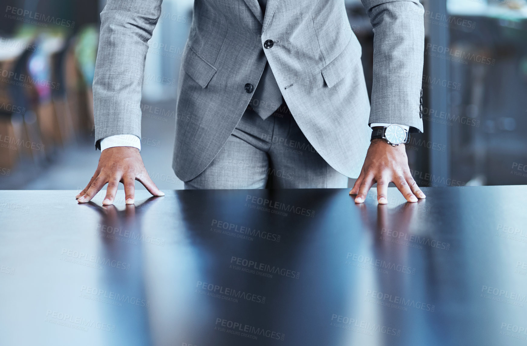 Buy stock photo Closeup shot of an unrecognizable businessman resting his hands on a table in an office