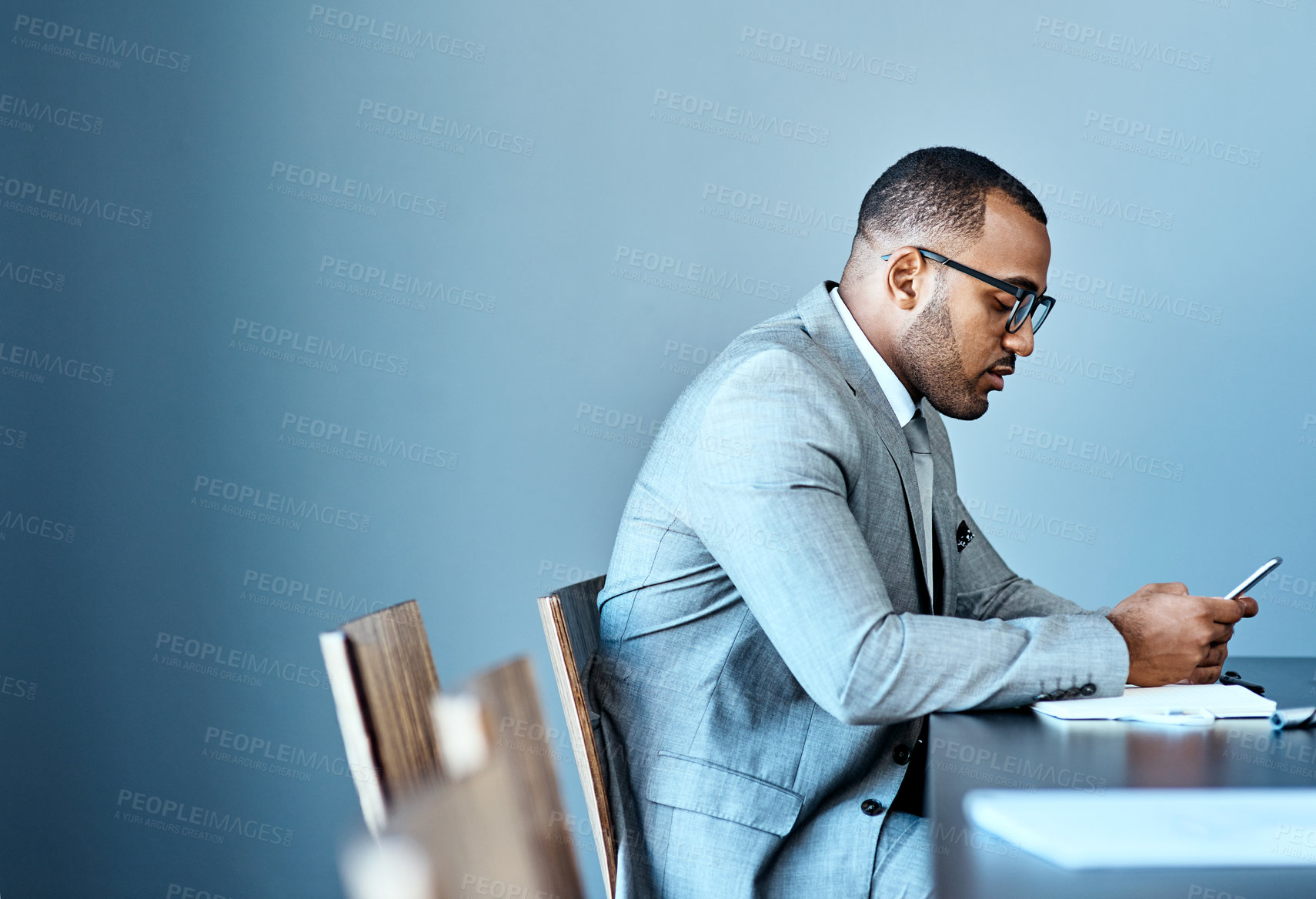 Buy stock photo Studio shot of a young businessman working against a grey background