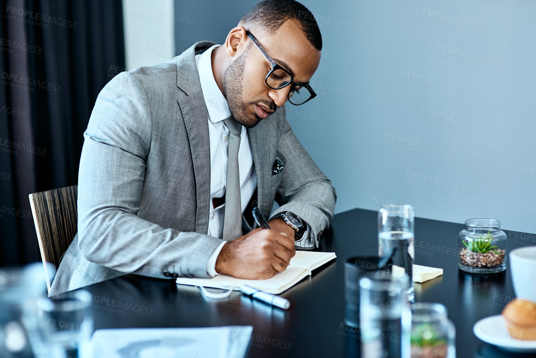 Buy stock photo Studio shot of a young businessman working against a grey background