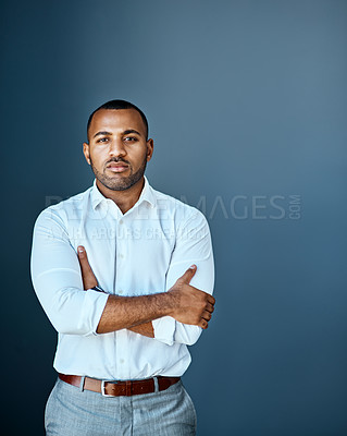 Buy stock photo Studio portrait of a young businessman standing against a grey background