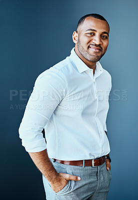 Buy stock photo Studio portrait of a young businessman standing against a grey background