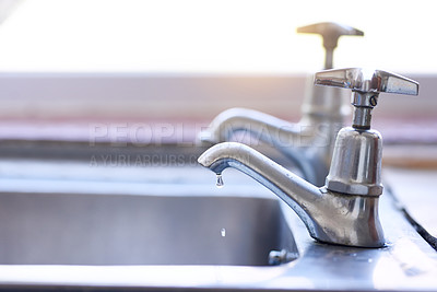 Buy stock photo Shot of two dripping taps waisting a little bit of water in a basin inside of a house during the day