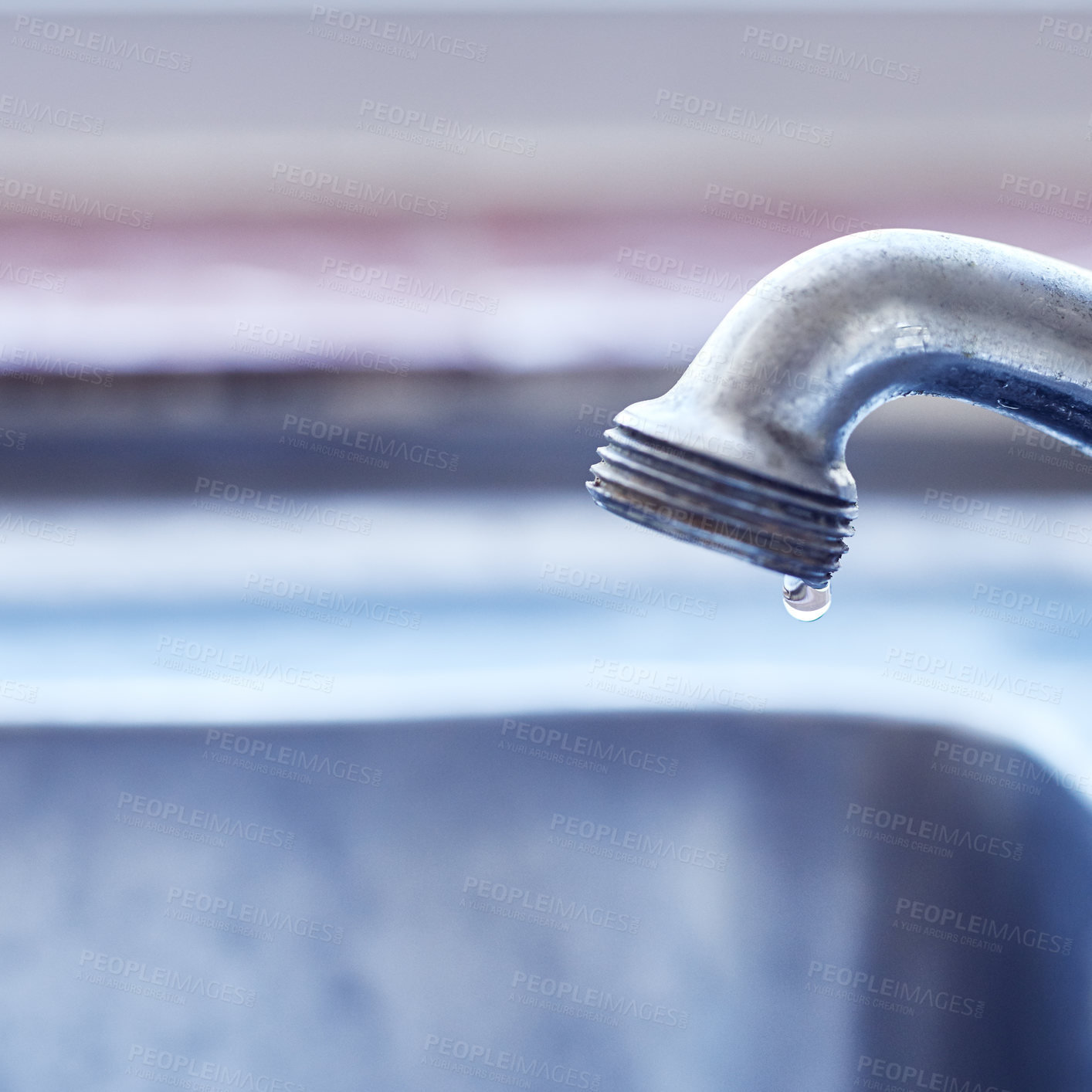 Buy stock photo Closeup of a dripping tap waisting a little bit of water in a basin inside of a house during the day