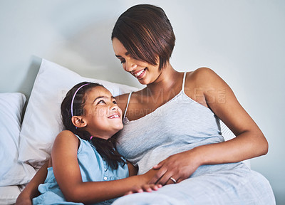 Buy stock photo Relax, child and pregnant woman on bed with bonding, smile and love in home together. Pregnancy, mother and daughter in bedroom with happy support, family growth and development in morning with care.