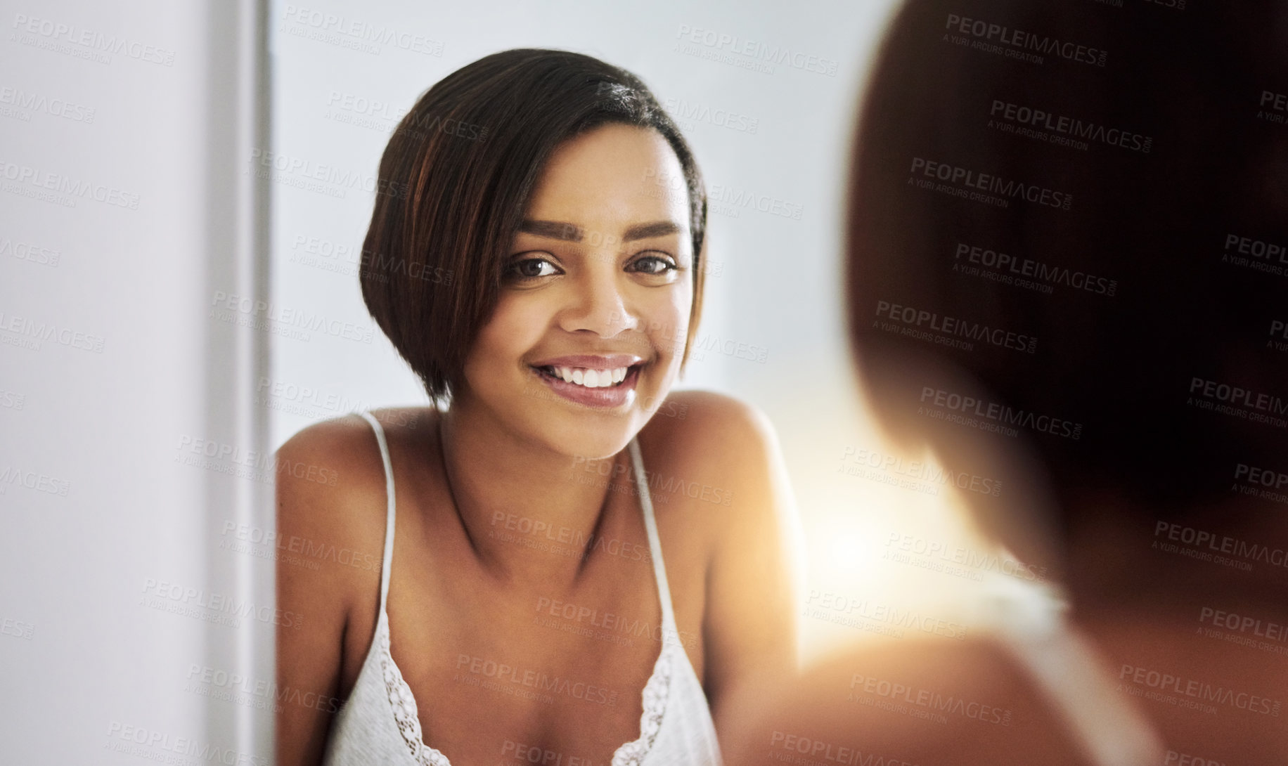 Buy stock photo Portrait of an attractive young woman looking at her face in the bathroom mirror