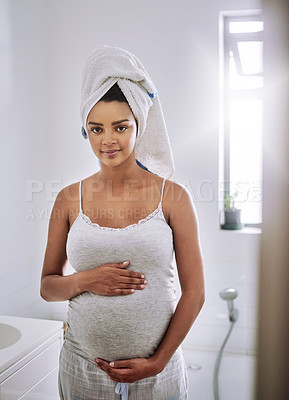 Buy stock photo Portrait of a pregnant young woman standing in the bathroom at home