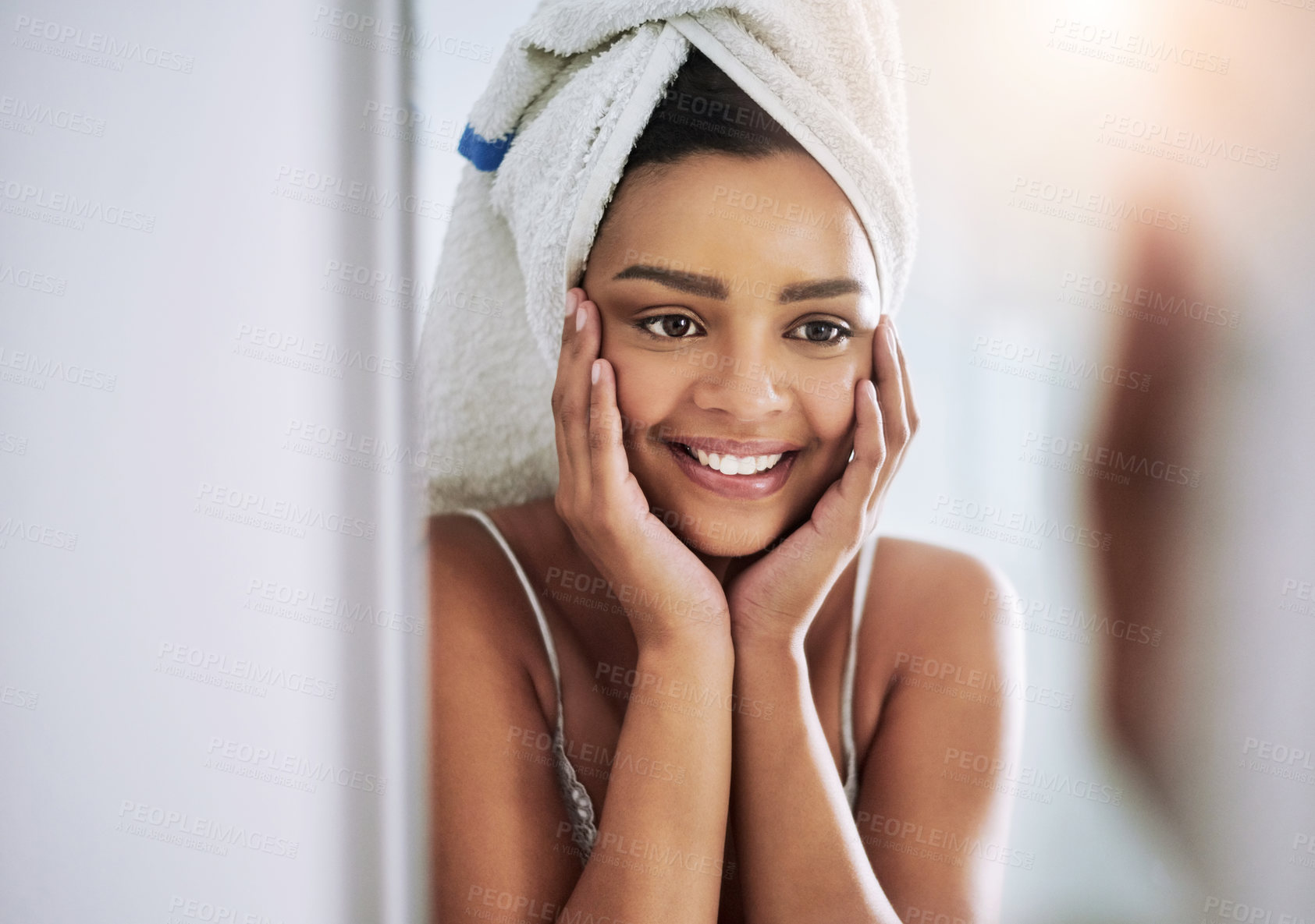 Buy stock photo Shot of an attractive young woman looking at her face in the bathroom mirror