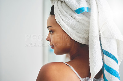Buy stock photo Shot of an attractive young woman standing in the bathroom at home