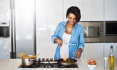 Buy stock photo Shot of a pregnant young woman preparing a meal on the stove at home