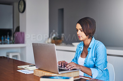 Buy stock photo Shot of a pregnant young woman using a laptop while working from home