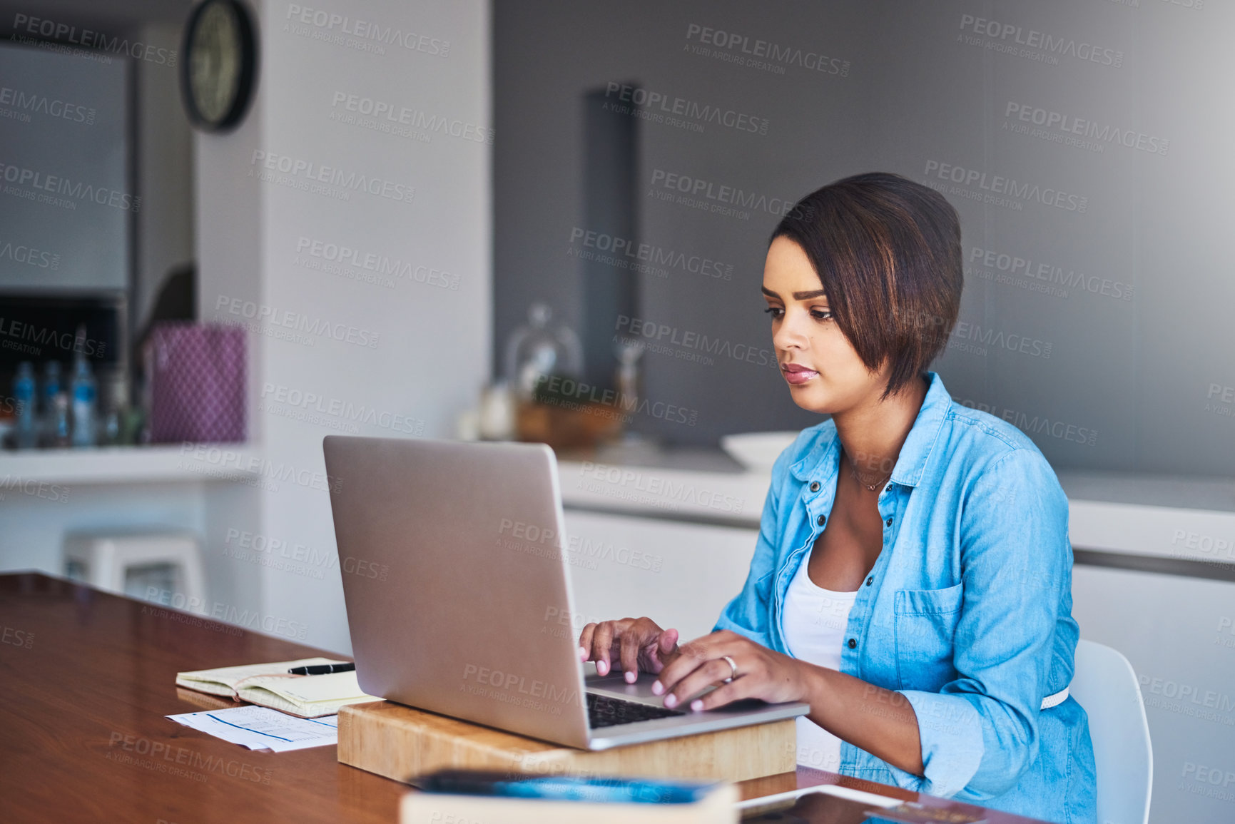 Buy stock photo Shot of a pregnant young woman using a laptop while working from home
