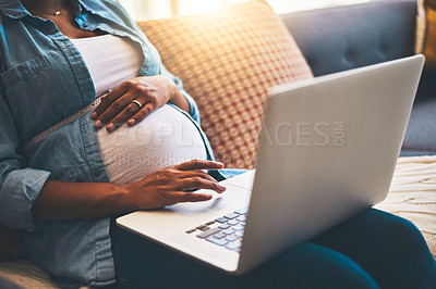 Buy stock photo Cropped shot of a pregnant woman using her laptop at home