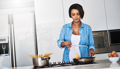 Buy stock photo Shot of a pregnant young woman preparing a meal on the stove at home