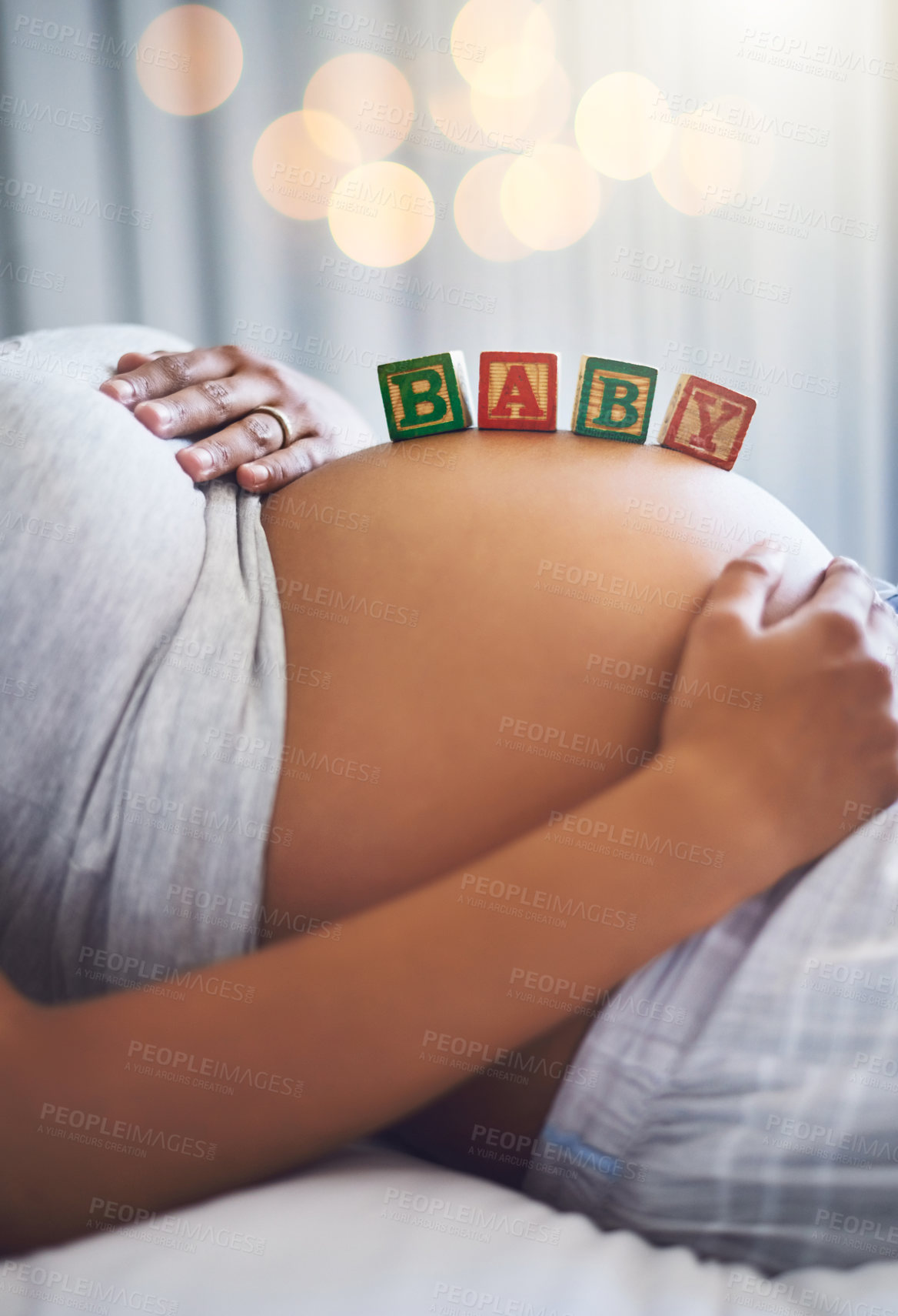 Buy stock photo Cropped shot of a pregnant woman with wooden blocks on her belly that spell the word baby
