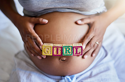 Buy stock photo Cropped shot of a pregnant woman with wooden blocks on her belly that spell the word girl