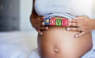 Buy stock photo Stomach, pregnant woman and hands with blocks for love, care or connection in home bedroom. Pregnancy, future mom or toy letters on body for prenatal support, health or bonding with baby in maternity