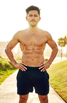Buy stock photo Portrait of a shirtless and muscular young man standing outdoors