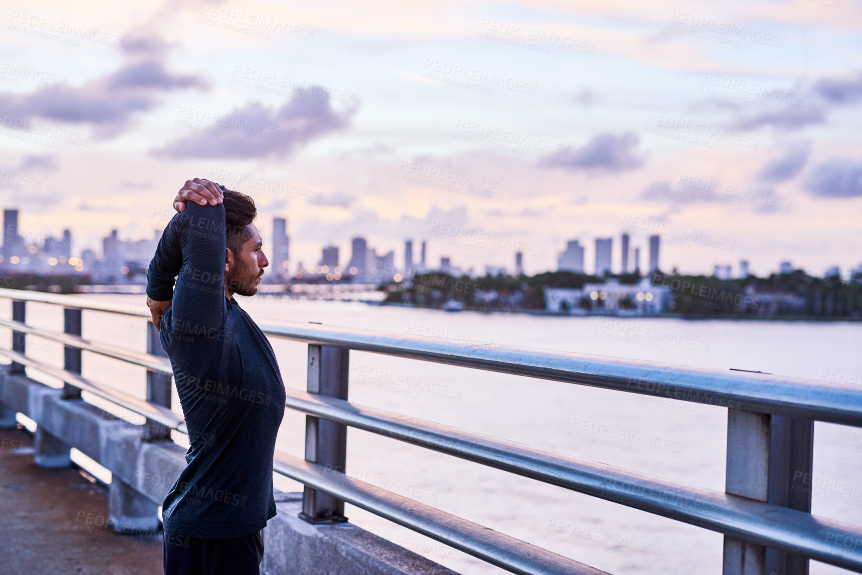 Buy stock photo Shot of a handsome young man exercising outdoors