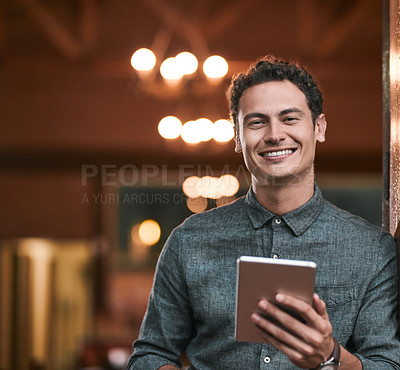 Buy stock photo Shot of a confident young man browsing on a digital tablet while standing inside of a beer brewery during the day