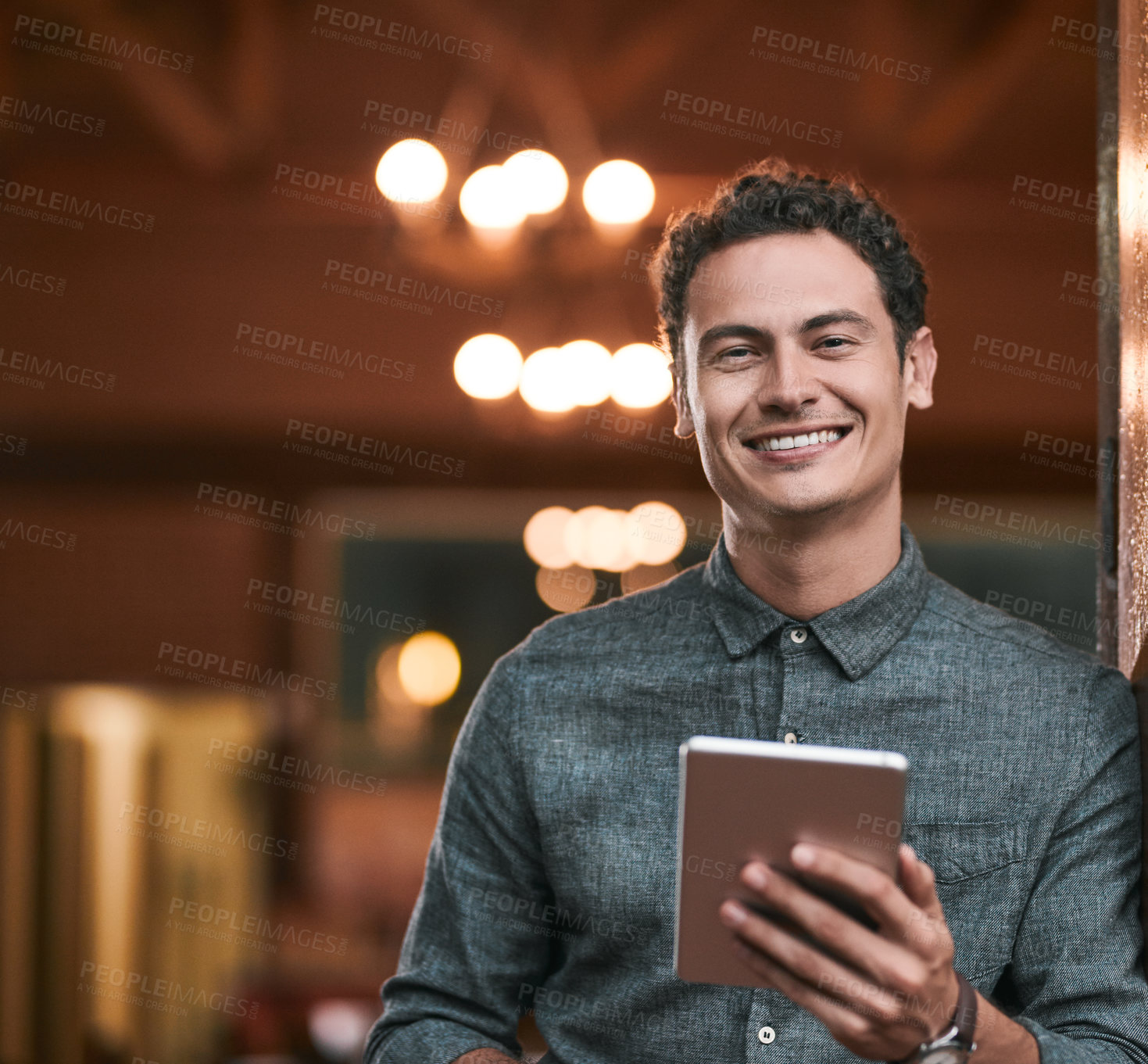 Buy stock photo Shot of a confident young man browsing on a digital tablet while standing inside of a beer brewery during the day