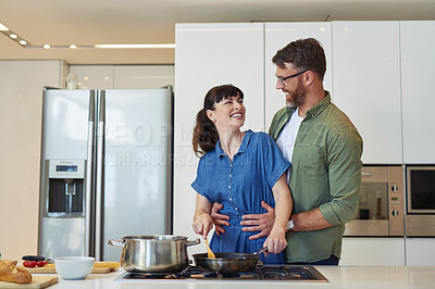 Buy stock photo Shot of a mature couple cooking together at home 