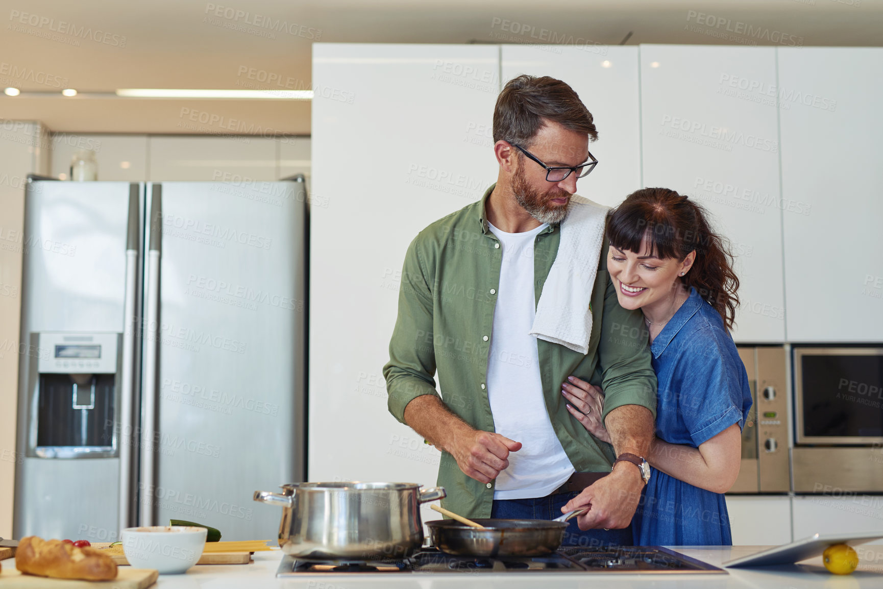 Buy stock photo Stove, counter and couple with cooking in kitchen for support, healthy diet and bonding together. Man, pan and love of woman with hug in marriage for nutrition, meal prep and dinner date in house