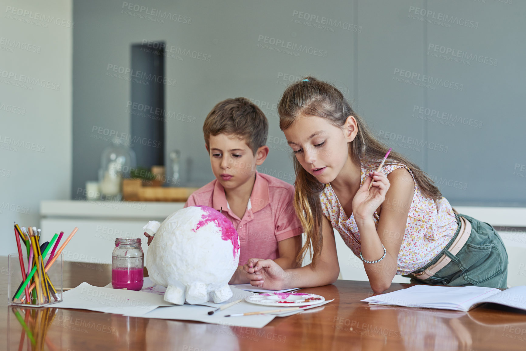 Buy stock photo Shot of two adorable little siblings painting together at home