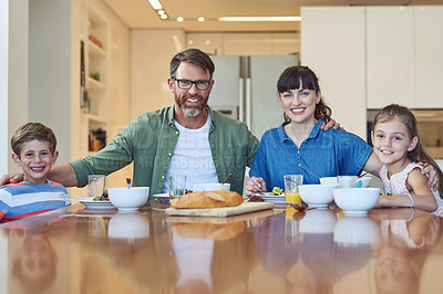 Buy stock photo Portrait of a happy family enjoying a meal together at home