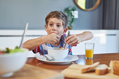 Buy stock photo Shot of an adorable little boy enjoying a meal at home