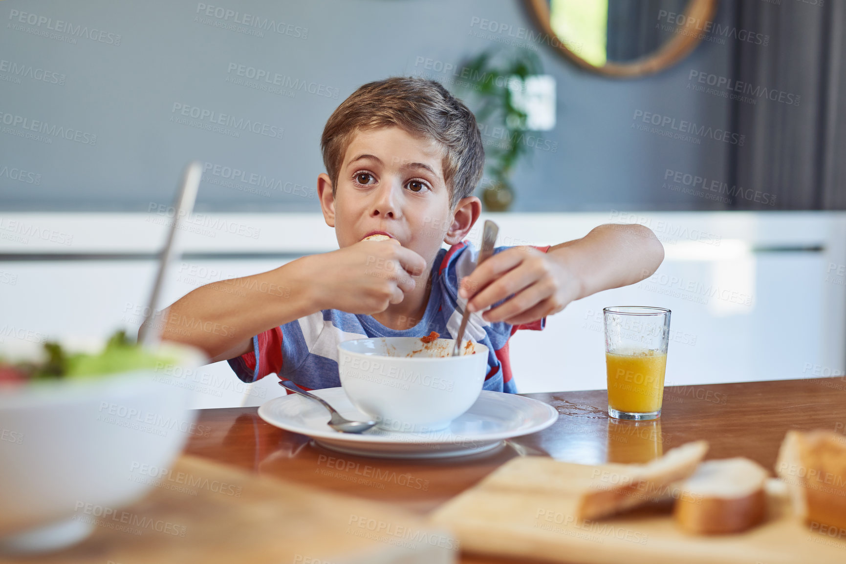 Buy stock photo Shot of an adorable little boy enjoying a meal at home