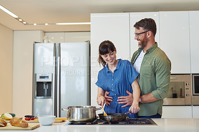 Buy stock photo Smile, hug and couple with cooking in kitchen for meal prep, healthy diet and romantic dinner together. Happy, man and woman with food ingredients by stove for marriage, support and nutrition at home