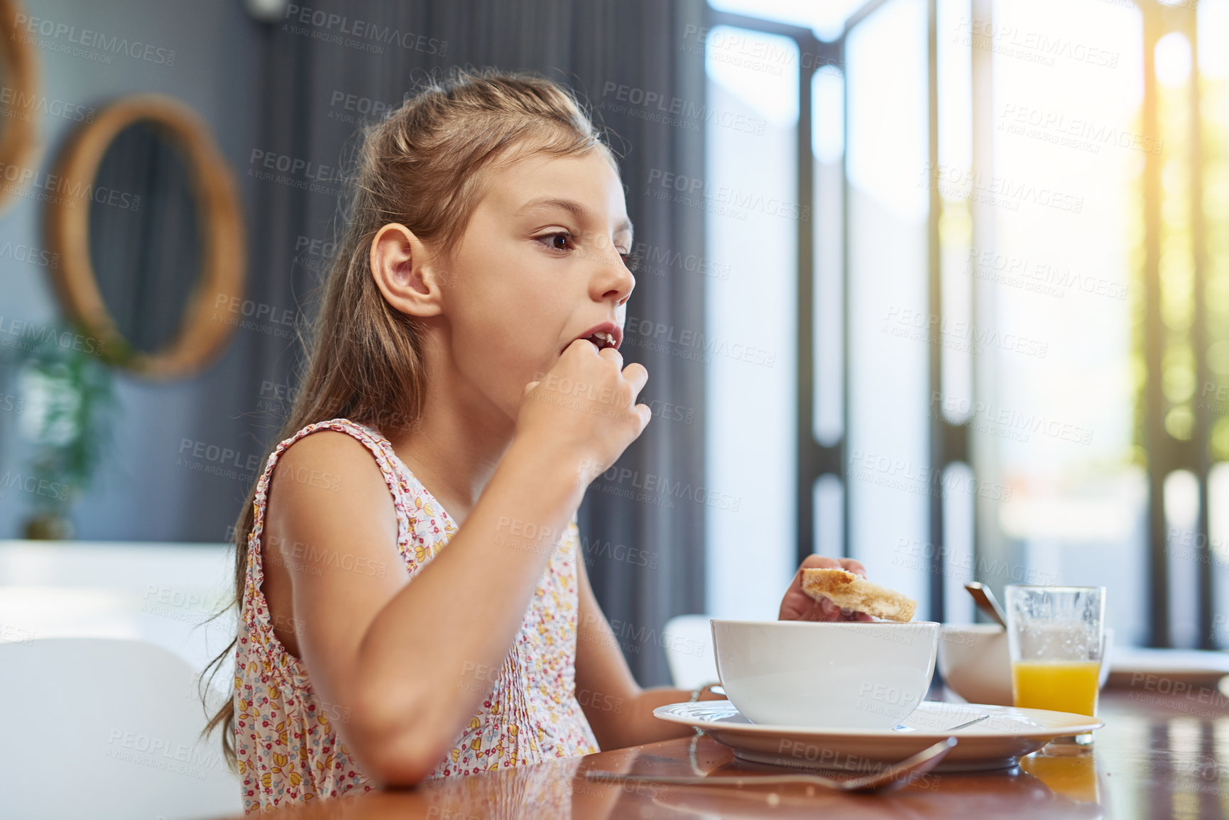 Buy stock photo Shot of an adorable little girl enjoying a meal at home
