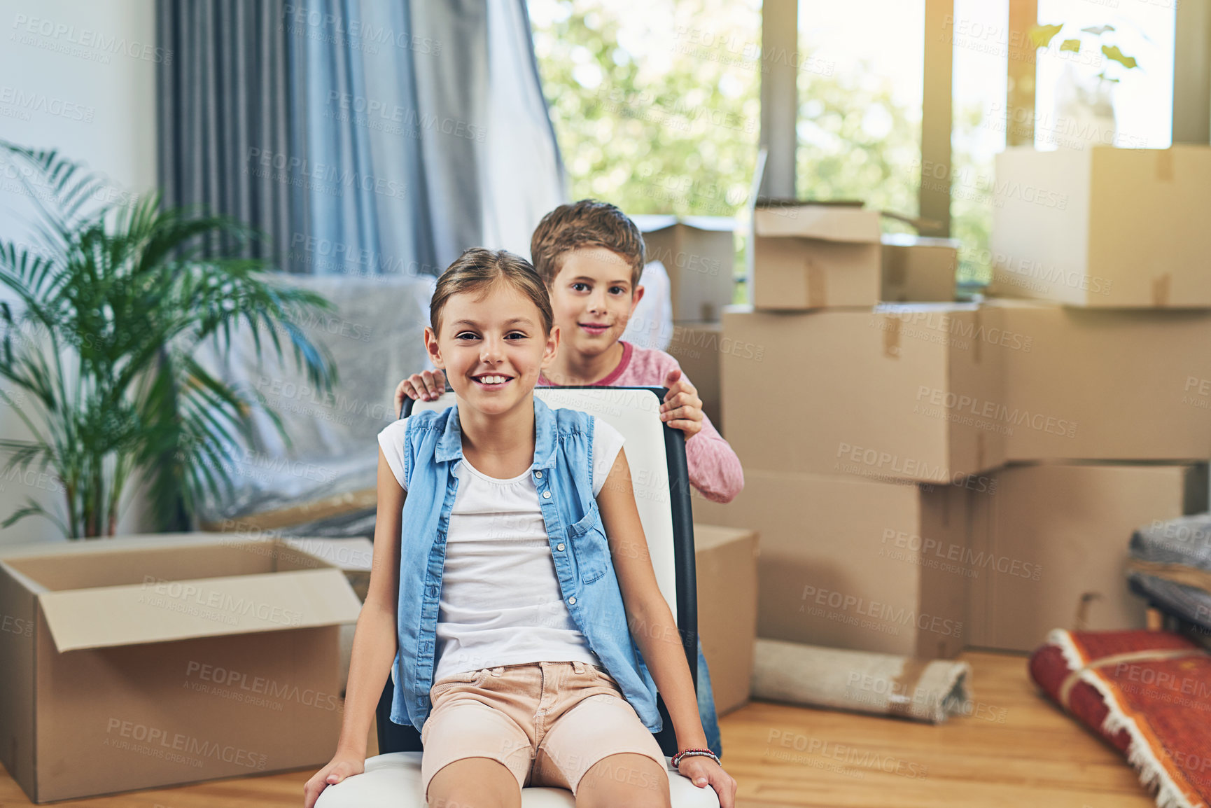 Buy stock photo Portrait, happy kids and moving to new home, property relocation and unpacking furniture. Smile, girl and boy in house for real estate, children bonding and family play together with sibling on chair