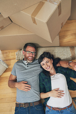 Buy stock photo High angle portrait of a happy couple relaxing together in their home on moving day