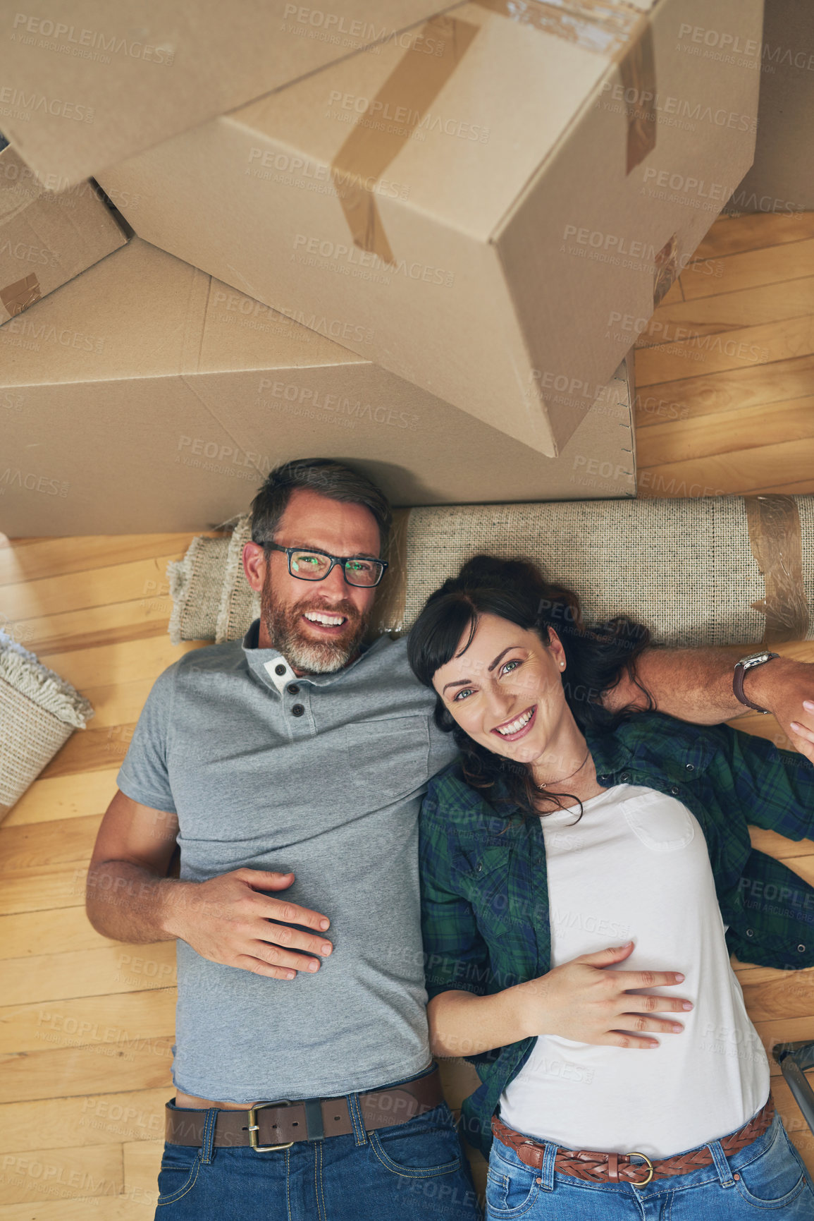 Buy stock photo High angle portrait of a happy couple relaxing together in their home on moving day
