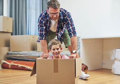Buy stock photo Portrait of a happy father and son having fun together on moving day