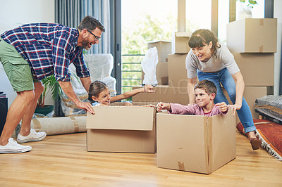 Buy stock photo Child, happiness and boxes with family moving in apartment for fun and enjoyment on the floor. Parents, happy and children excited in a box at family home for investment and a lifestyle with love.