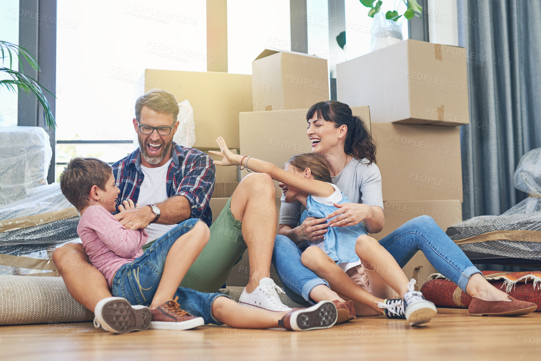 Buy stock photo Happy, family and moving with boxes in apartment on the floor are excited with the mortgage. Parents, children and new home for investment are playful with box in the living room of property. 