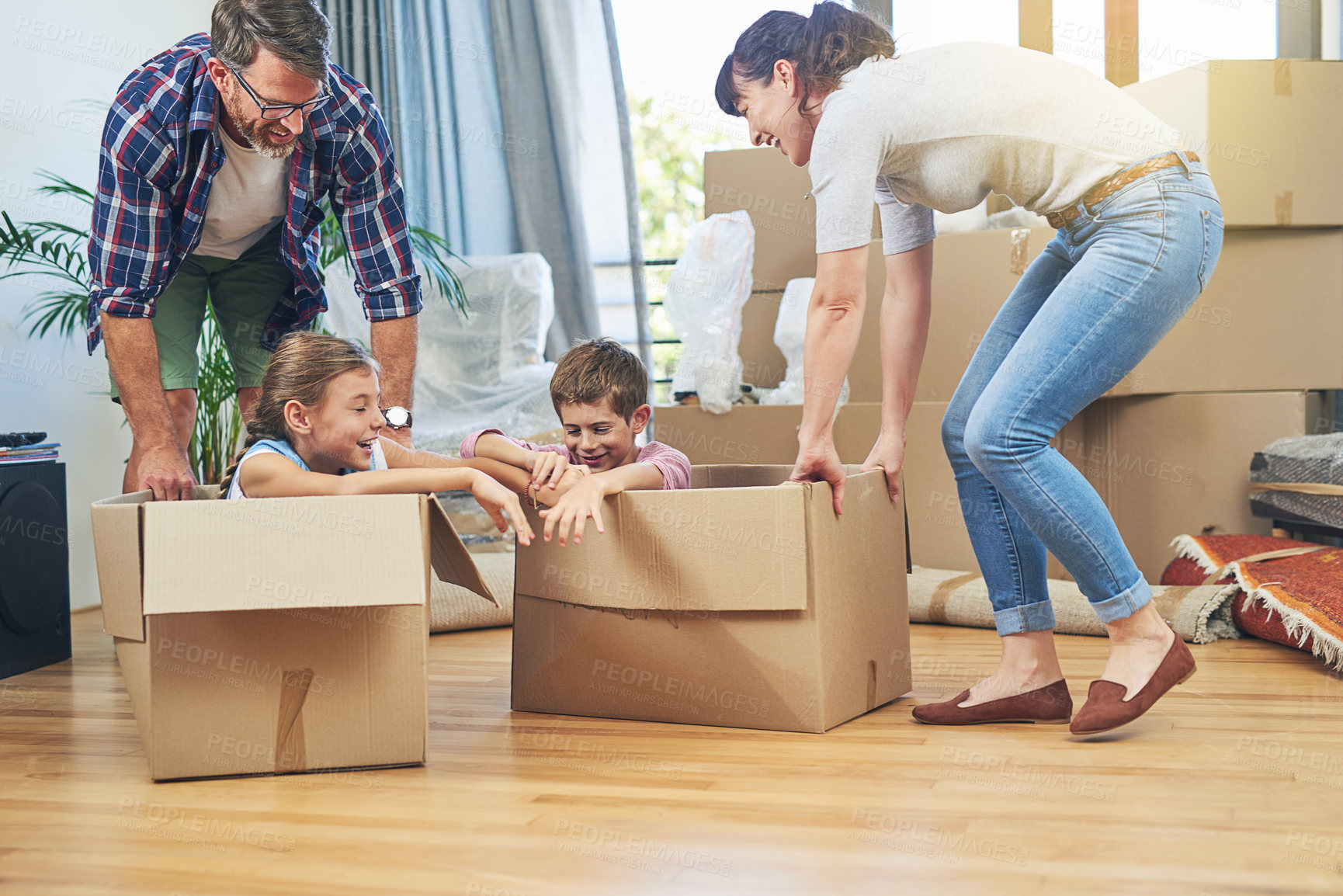 Buy stock photo Shot of a happy family having fun together on moving day