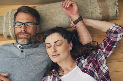 Buy stock photo High angle shot of a couple taking a nap together on moving day