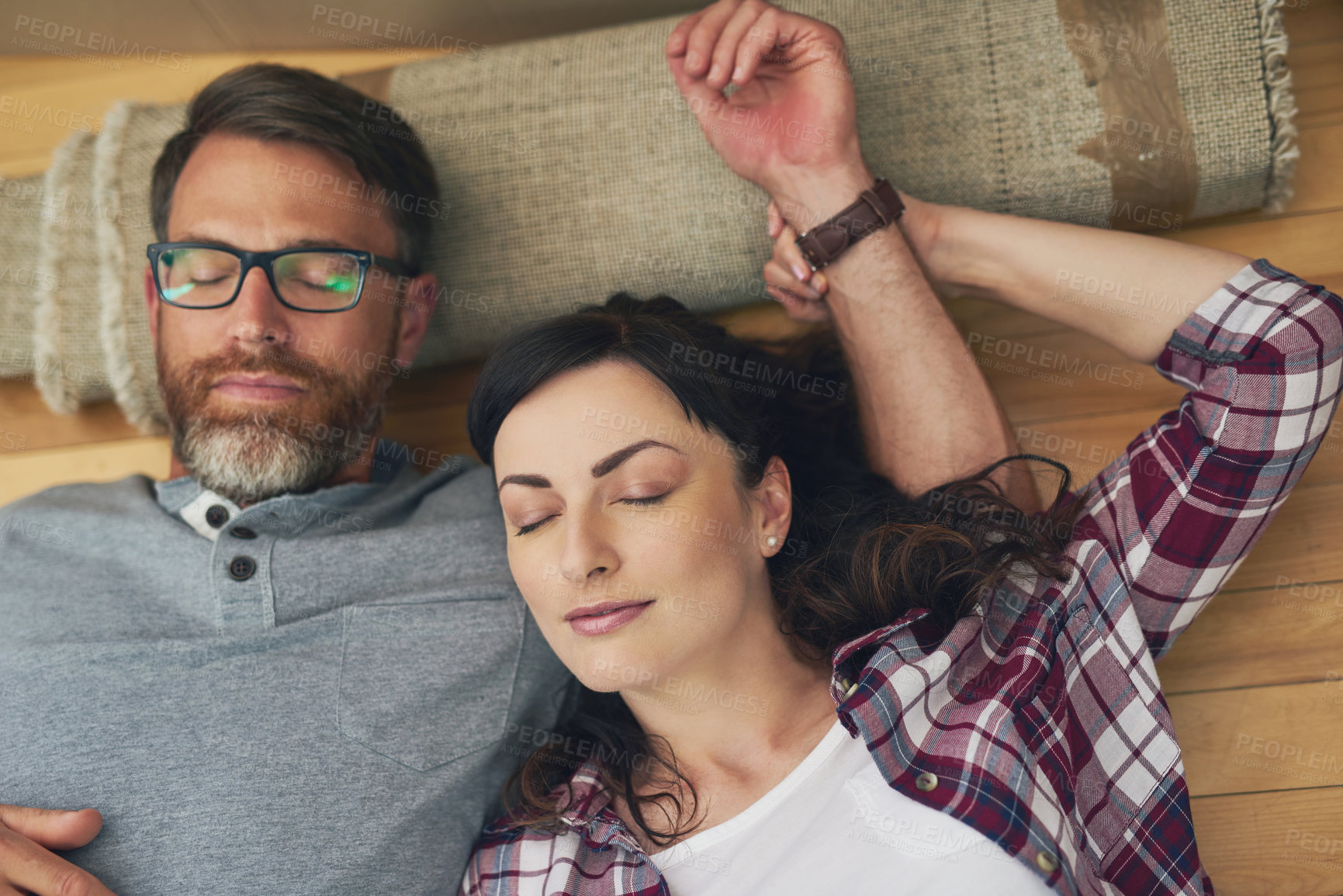 Buy stock photo High angle shot of a couple taking a nap together on moving day