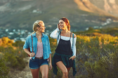 Buy stock photo Cropped shot of two beautiful female friends hiking in nature