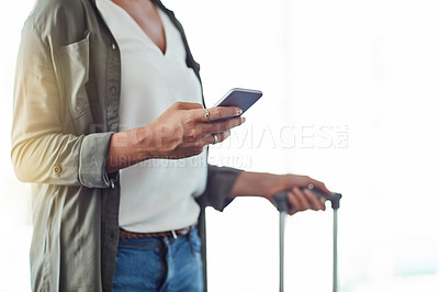 Buy stock photo Cropped shot of an unrecognizable woman using a cellphone in an airport