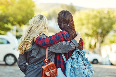 Buy stock photo Rearview shot of two unrecognizable female friends sight seeing in the city