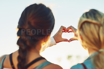 Buy stock photo Women, friends and back with heart hands in nature for love, friendship or relationship. Female people, emoji or sign with sunshine for bonding, care or support together on outdoor holiday or weekend