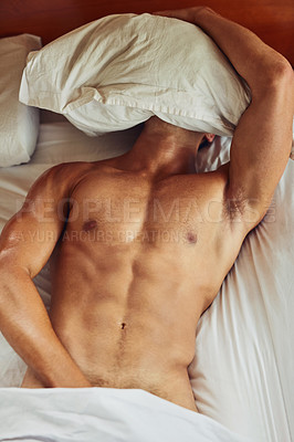 Buy stock photo Shot of an unrecognizable man lying topless on his bed while trying to sleep in the morning at home