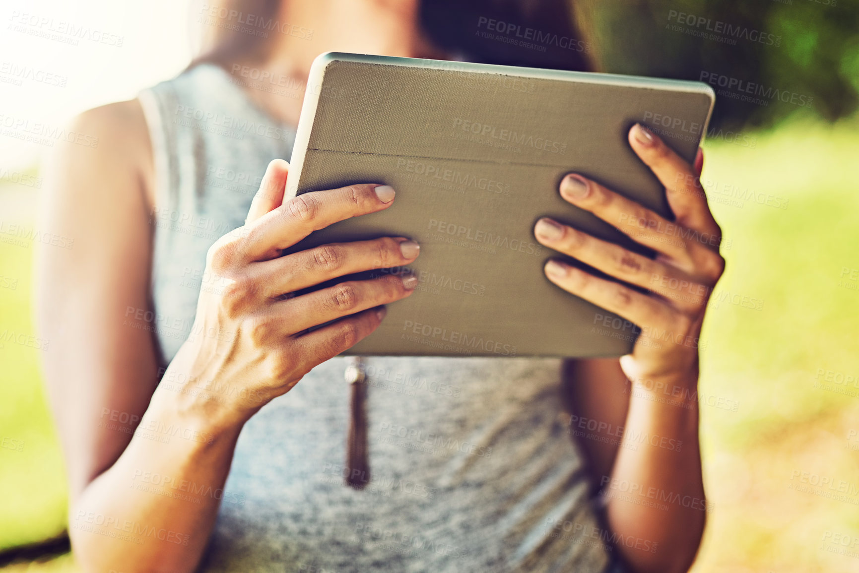 Buy stock photo Closeup shot of an unrecognizable woman using a digital tablet outdoors