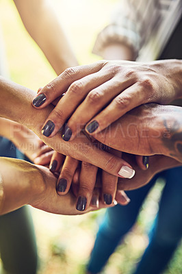 Buy stock photo Closeup shot of an unrecognizable group of people joining their hands in a huddle outdoors